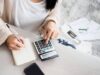 How to Create a Personal Budget That Actually Works Person creating a personal budget with a laptop and calculator