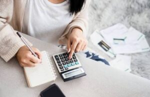 How to Create a Personal Budget That Actually Works Person creating a personal budget with a laptop and calculator