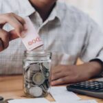 Emergency savings fund planned with a calculator and financial documents