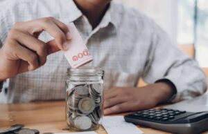 Emergency Fund: How Much Should You Save? Emergency savings fund planned with a calculator and financial documents