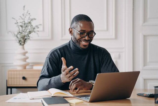Entrepreneur working on an online business from a laptop Entrepreneur building an online business with a laptop